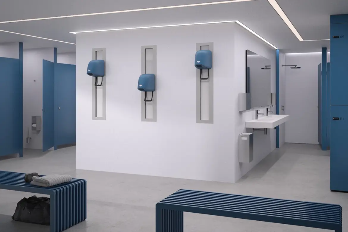 Fastmonterte, veggmonterte hårfønere i offentlig garderobe ved dusjsoner – en robust og vandalsikker løsning for svømmehaller, idrettsanlegg og treningssentre med høy bruk og krav til driftssikkerhet.